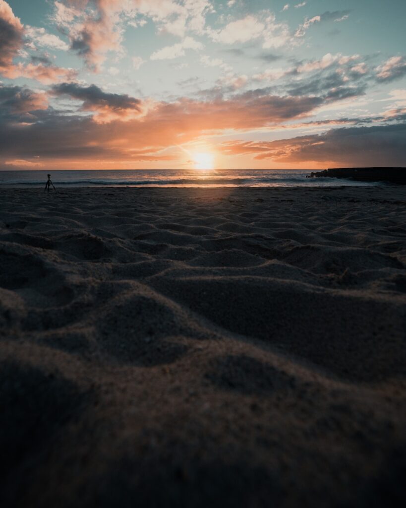 seashore showing calm sea under sunrise