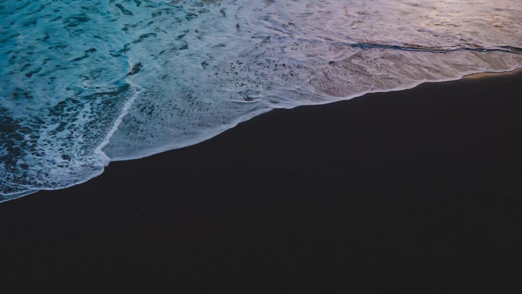 a person riding a surfboard on top of a wave