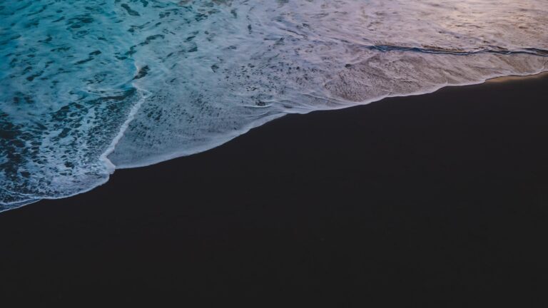 a person riding a surfboard on top of a wave